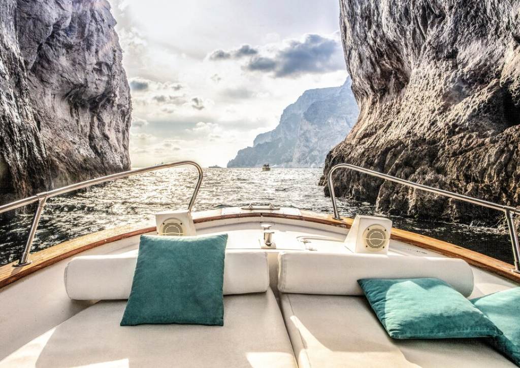 Luxury boat tour exploring hidden coves and grottos near Capri island from Amalfi Coast itinerary.