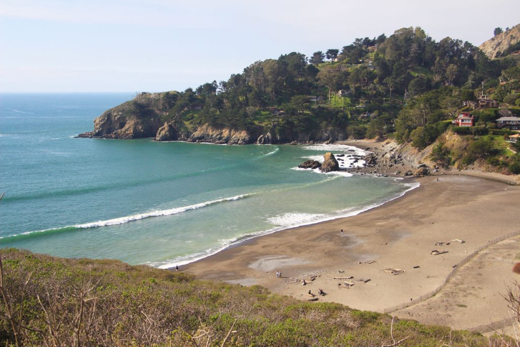 Hidden California beach with rugged cliffs and crystal-clear ocean water